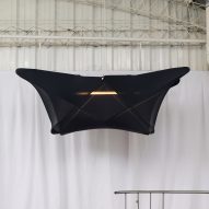 A hanging lamp covered in black fabric