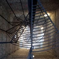Spiral staircase surrounded by concrete walls