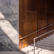 Public staircase with timber and grey marble walls