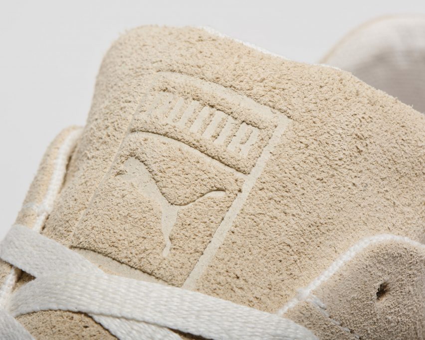 Close-up of the tongue of Puma's Re:Suede sneaker showing a fuzzy cream-coloured suede leather upper with an embossed Puma logo and off-white hemp laces