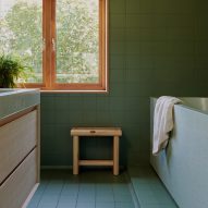 Bathroom with green tiles and terrazzo bath and basin