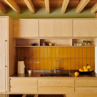 Kitchen with ask cabinets and yellow tile splashback