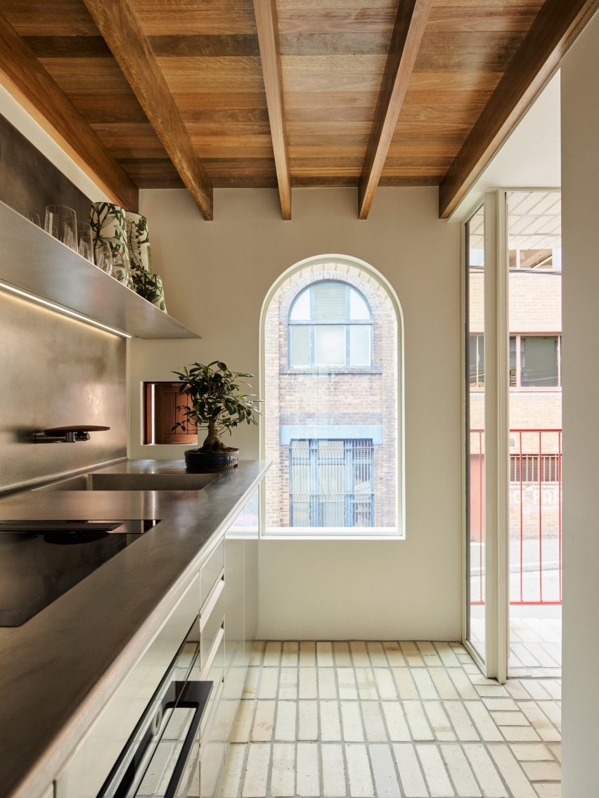 Pale kitchen with wooden ceiling 