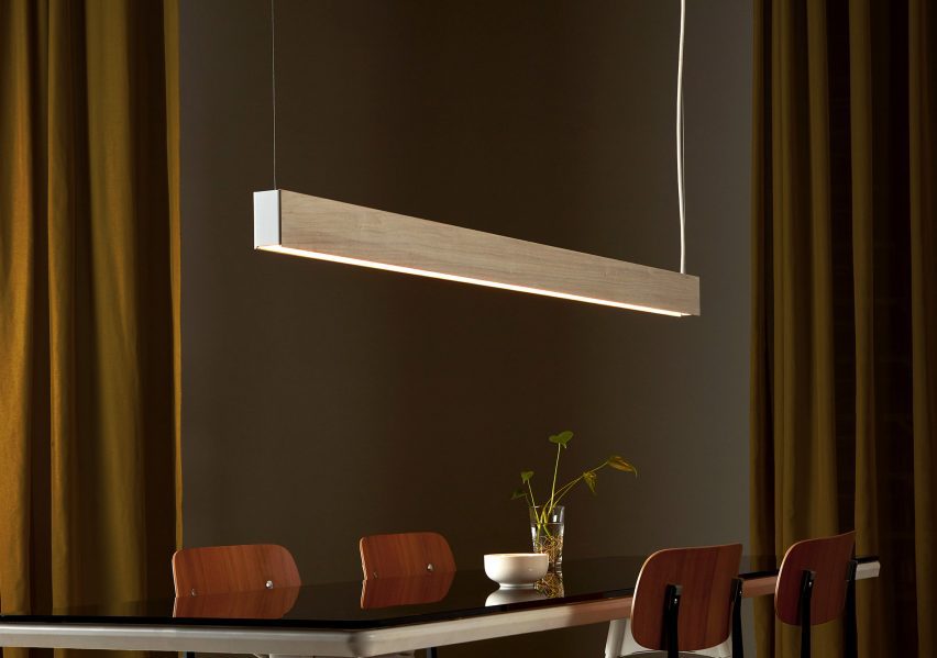 White wooden linear light hanging over table