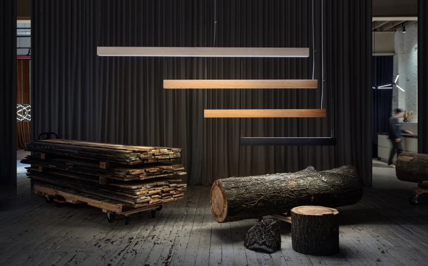Logs of reclaimed wood with finished lighting product above