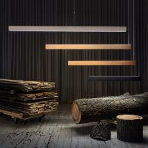 Linear lights hanging over reclaimed wood timber and stumps