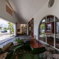 Entryway with semicircular window at Tile House by The Bloom Architects