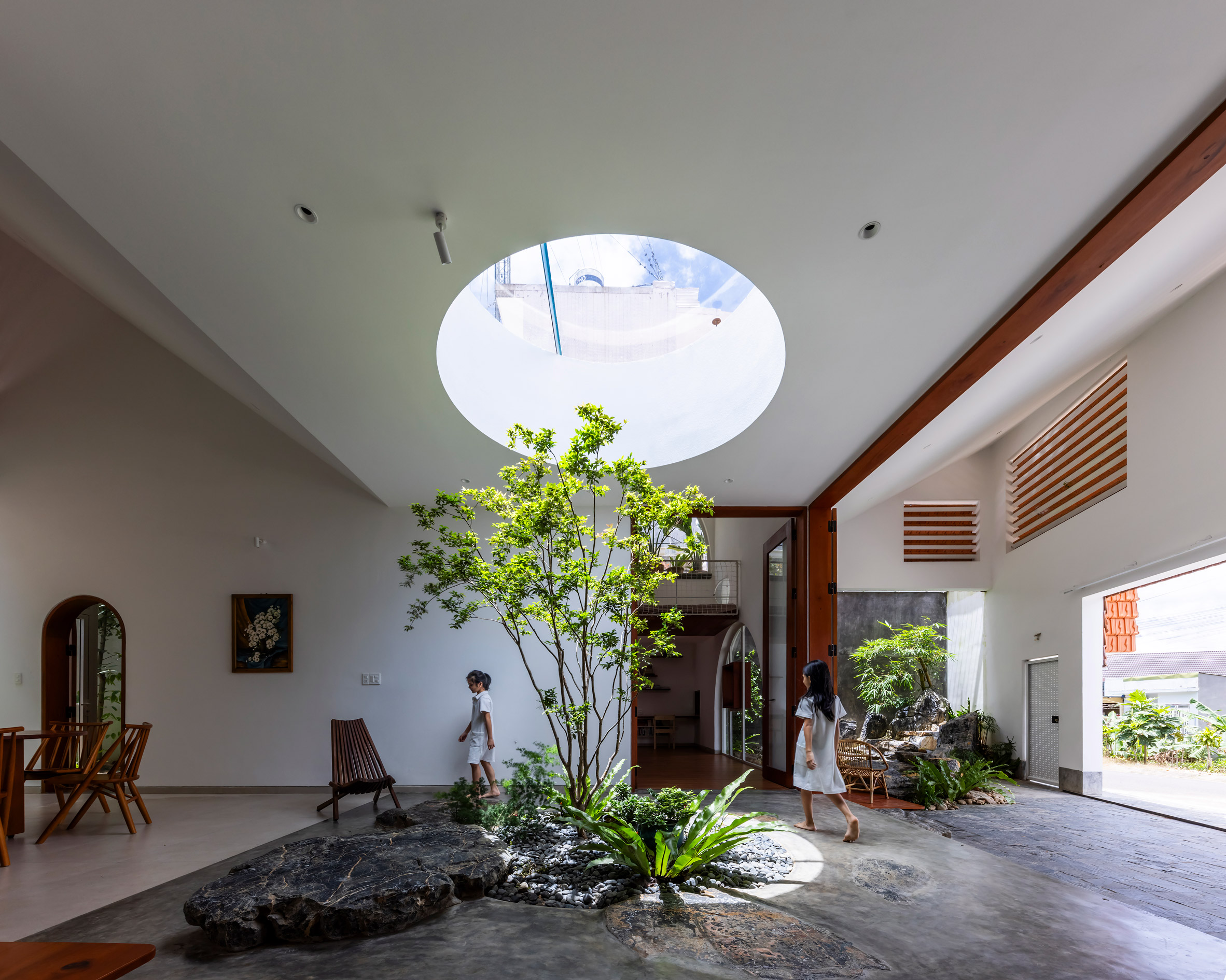 Oculus lighting an internal planted tree in a home in Vietnam