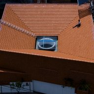 Sloping red-tiled roof with an oculus
