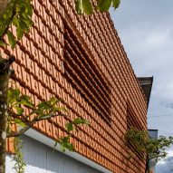 Red-tiled wall at Tile House by The Bloom Architects