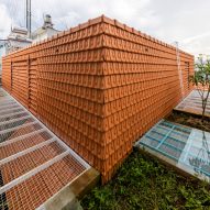 Red-tiled exterior walls at Tile House by The Bloom Architects