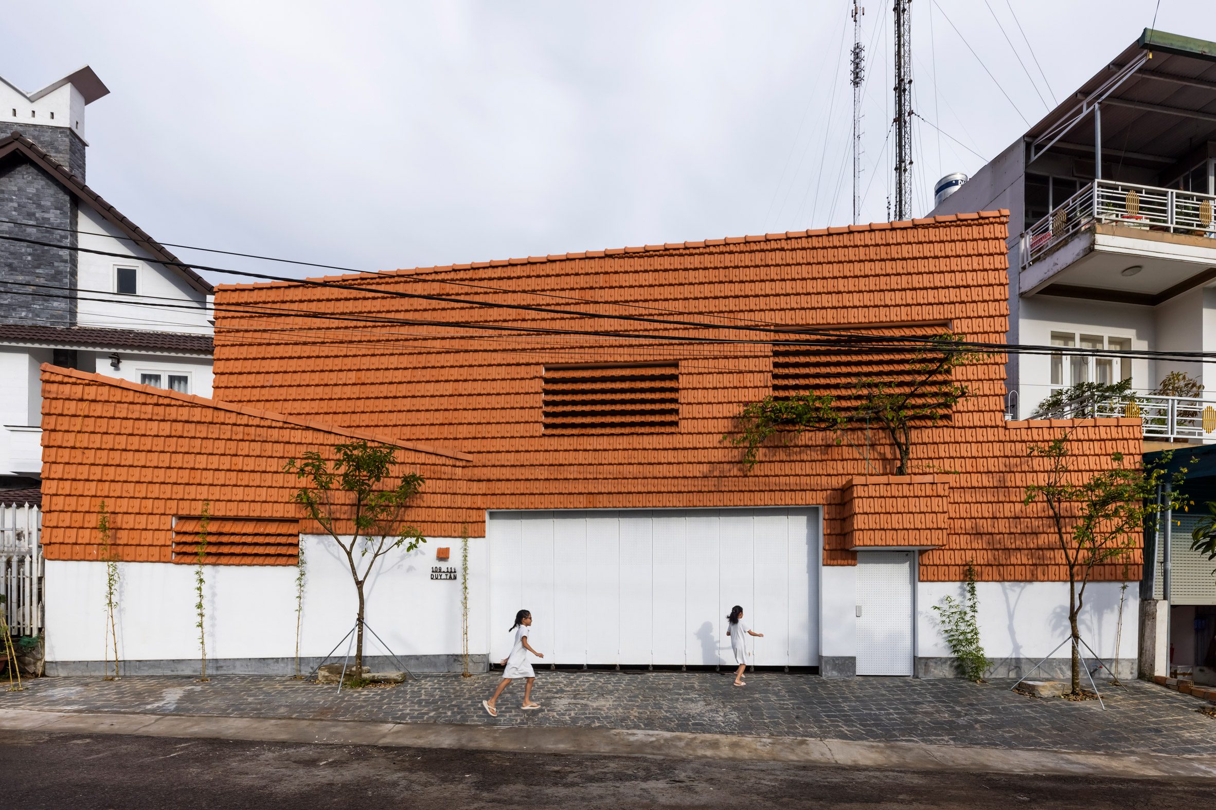 Exterior of Tile House clad in red tiles by The Bloom Architects