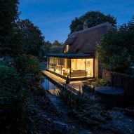 Greenaway Architecture added a contemporary glazed extension to a thatched cottage