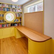 Yellow library and study space with round porthole window