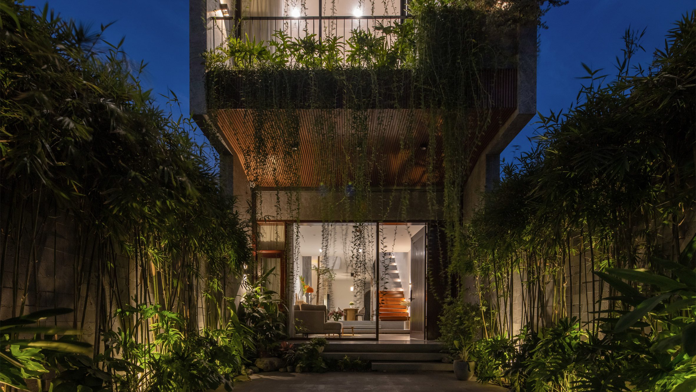 Exterior and garden at night in De Chill House in Vietnam by X11