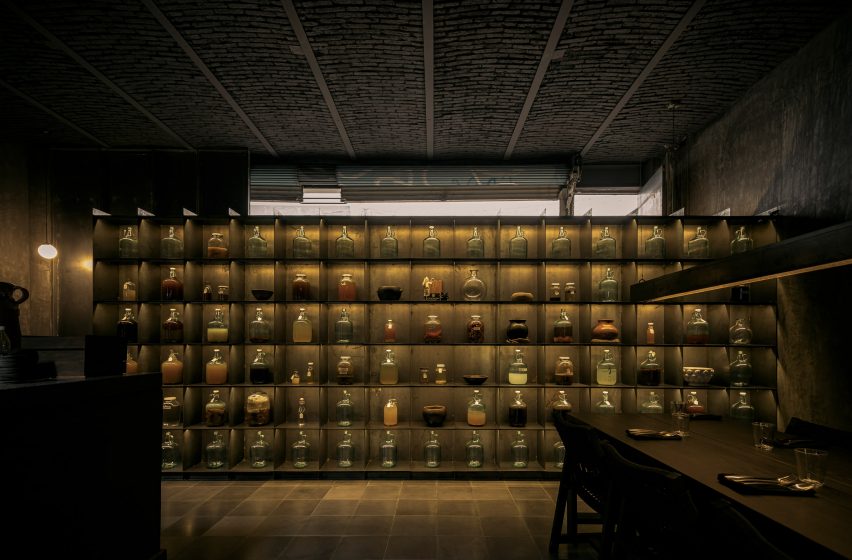 A grid of shelves holding glass jars