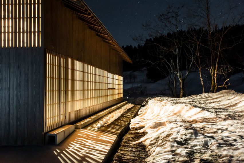 Nighttime exterior shot of light spilling out of Yukinohako snow-powered cool store by Kei Kaihoh Architects in Joetsu City, Niigata Prefecture