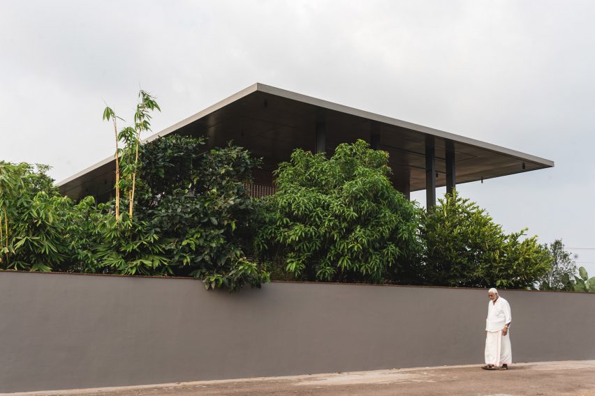 Exterior view of Indian home with large concrete roof