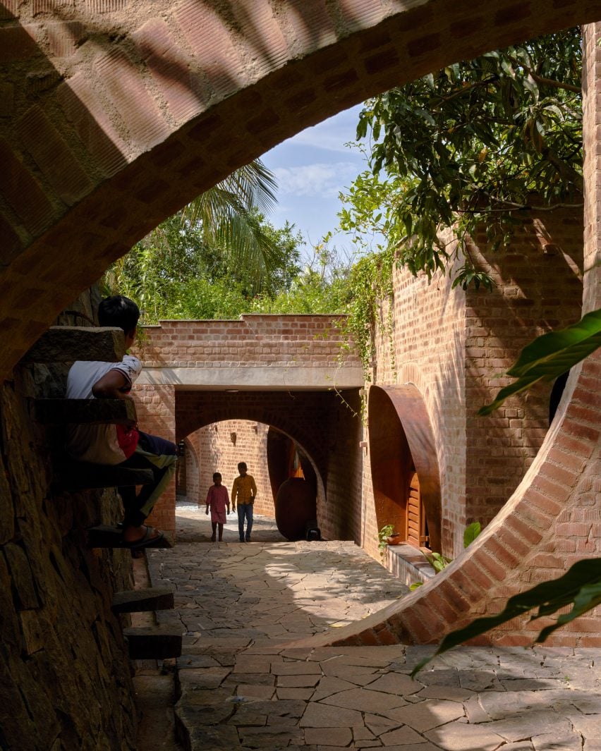 Brick arches and wall enclosures at the community centre in Bangalore by A Threshold