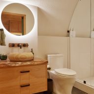 A white bathroom with wooden vanity