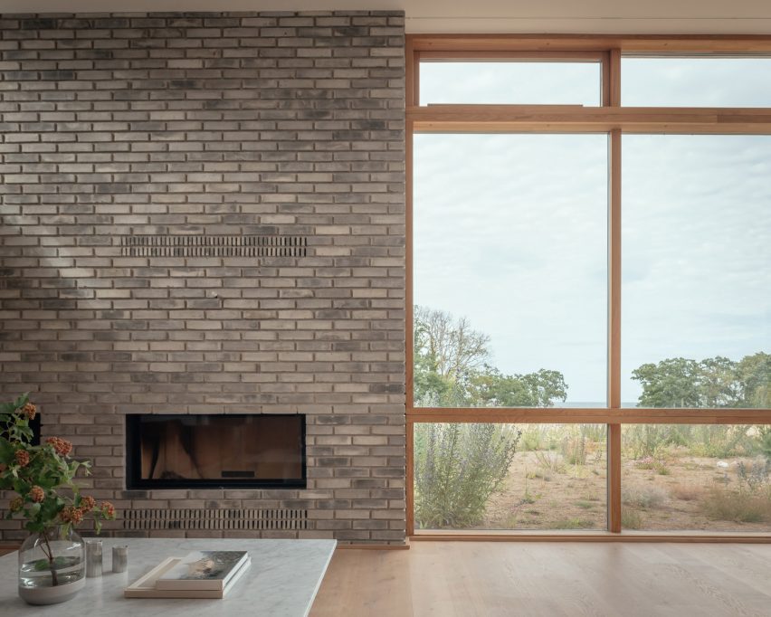 Internal grey brick and window in blocky white home in Sweden by Asa Hjort Architects