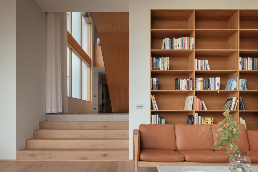 Wooden interior of living area in blocky white home in Sweden by Asa Hjort Architects