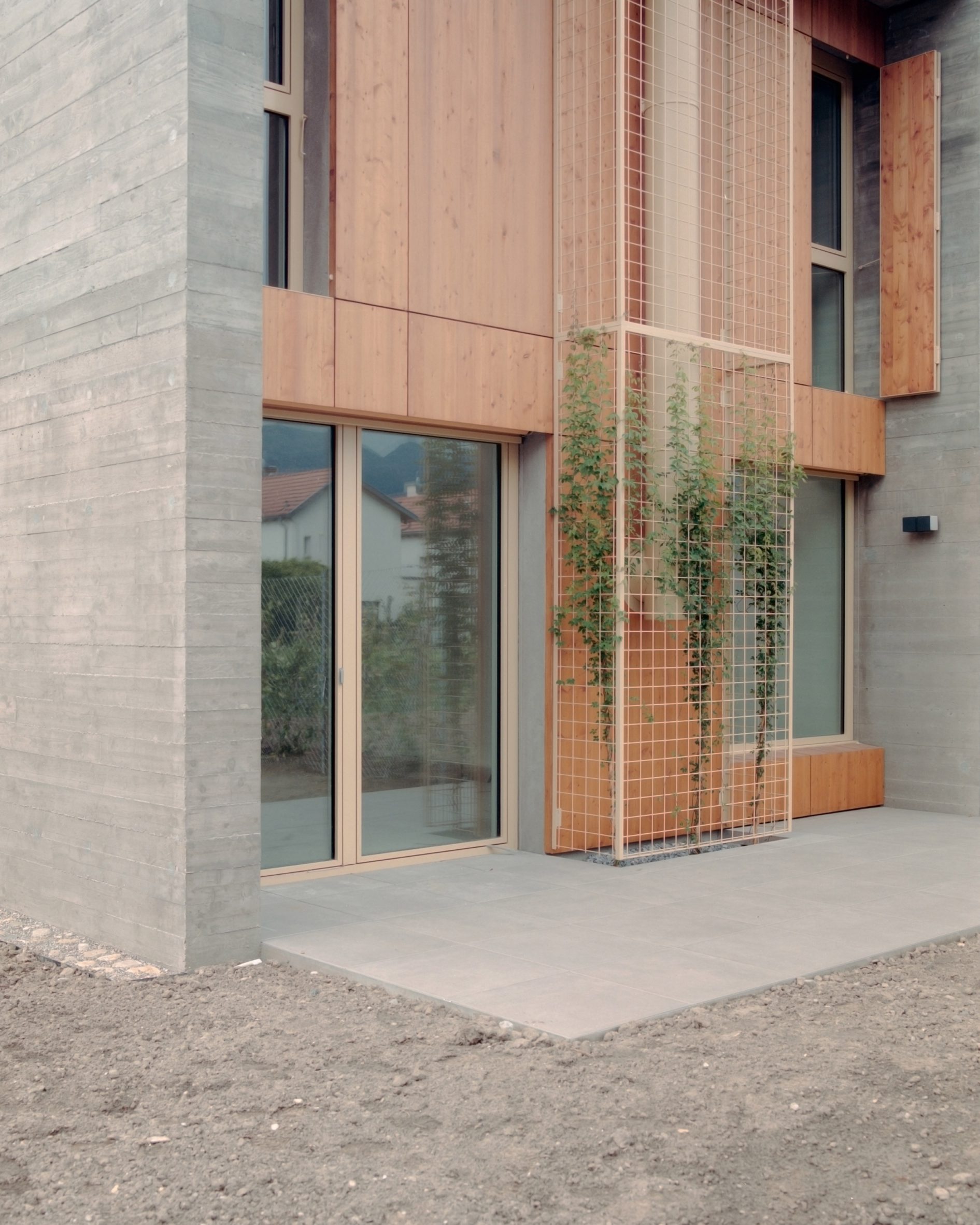 External concrete and timber panelling of terrace houses in Switzerland by Atelier Rampazzi