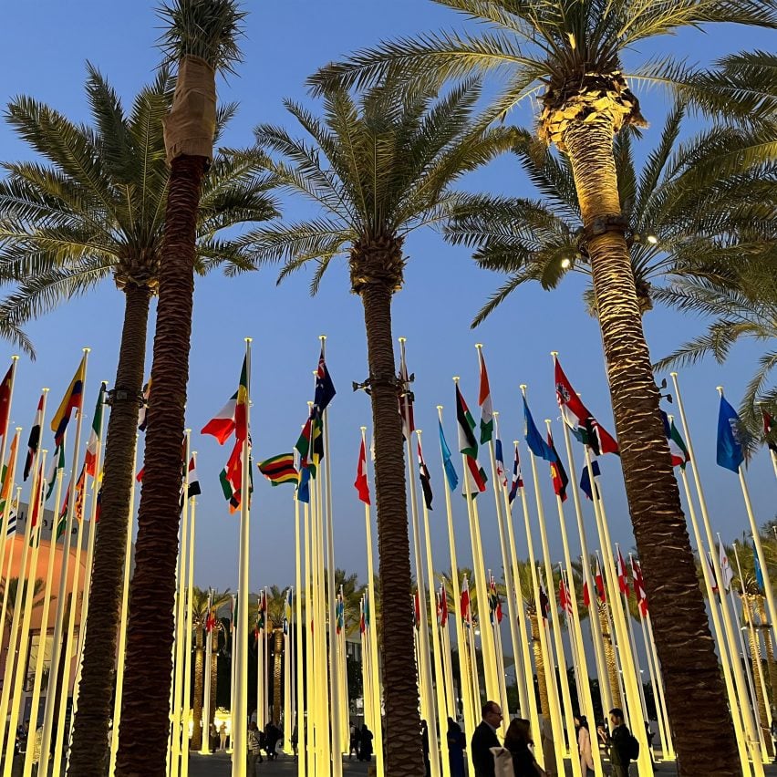 Flagpoles and palm trees at COP28 in Dubai