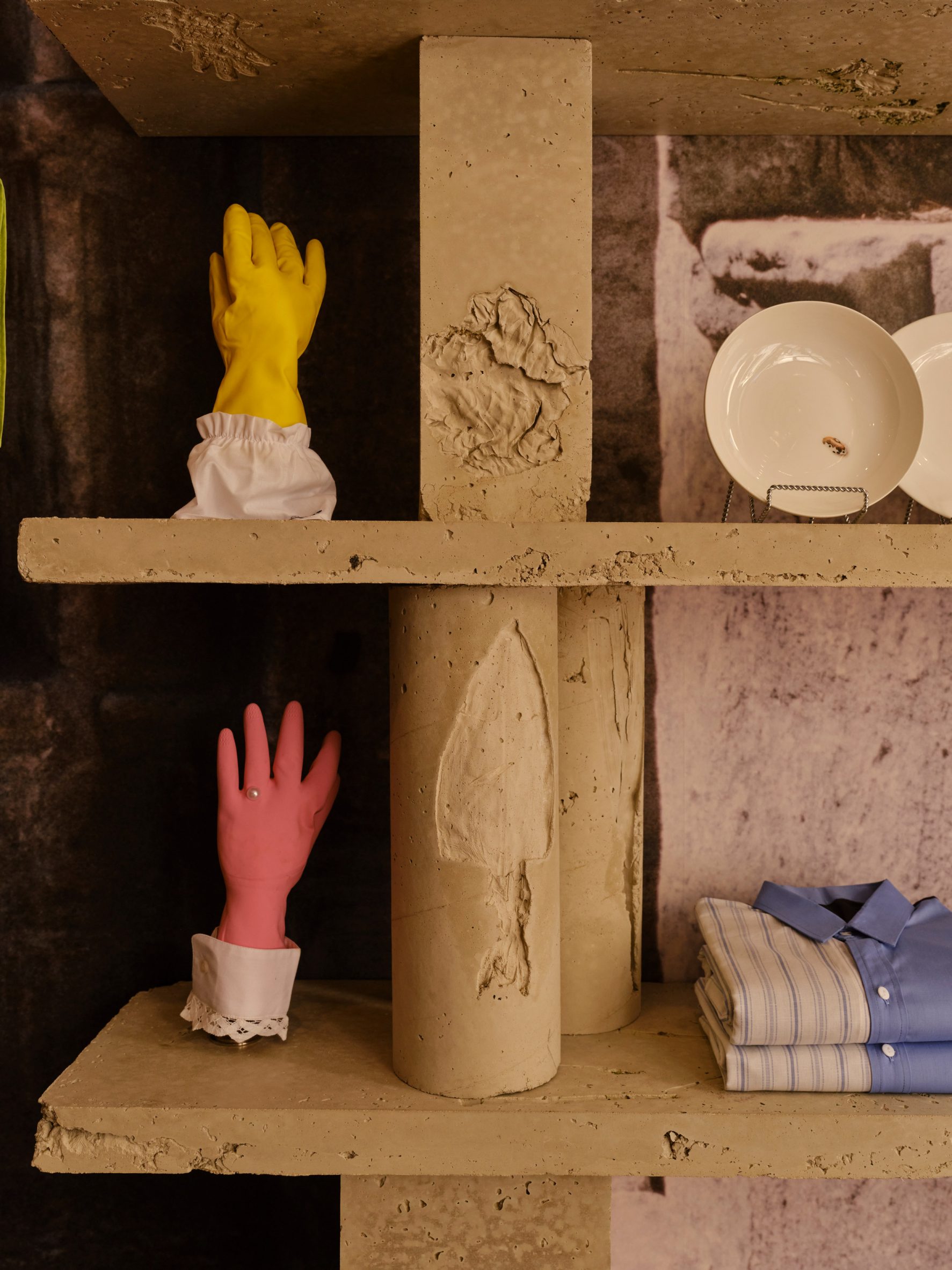 Homeware and clothing displayed on concrete shelves