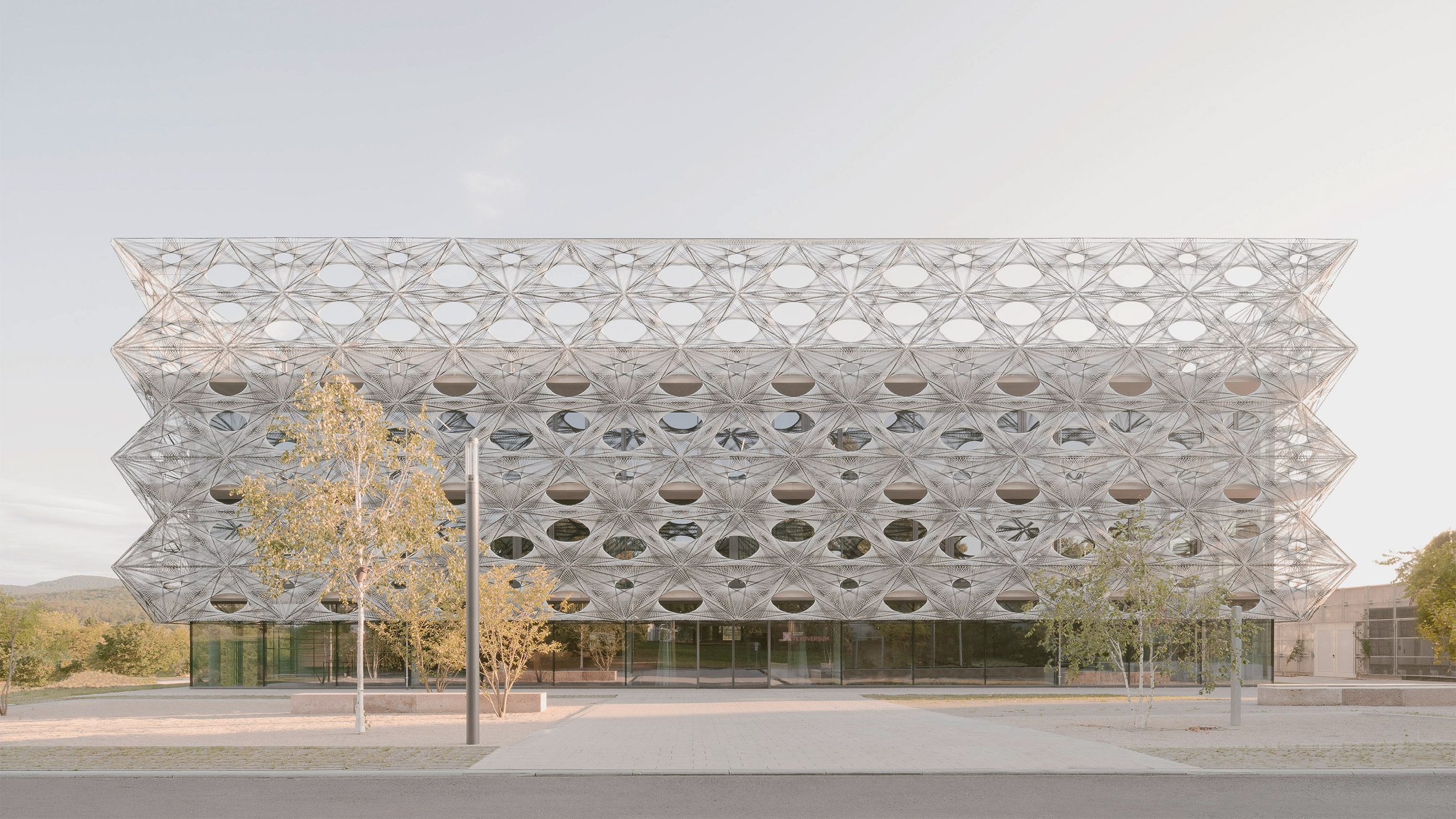 Robotically woven fibres wrap Texoversum university building in