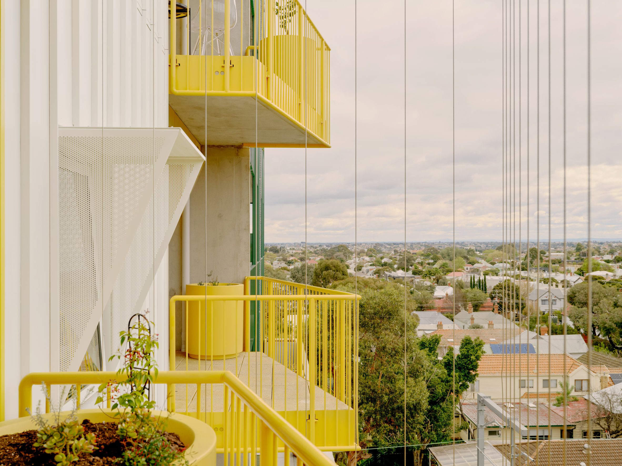 Yellow balconies of ParkLife apartment block in Melbourne by Austin Maynard Architects