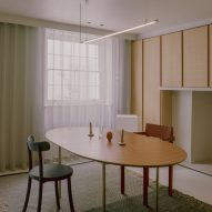 Dining room with a wood table and wood wall cupboards