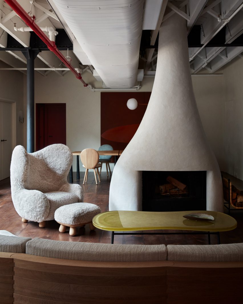 Sculptural fireplace accompanied by Pierre Yovanovitch's iconic Bear Chair