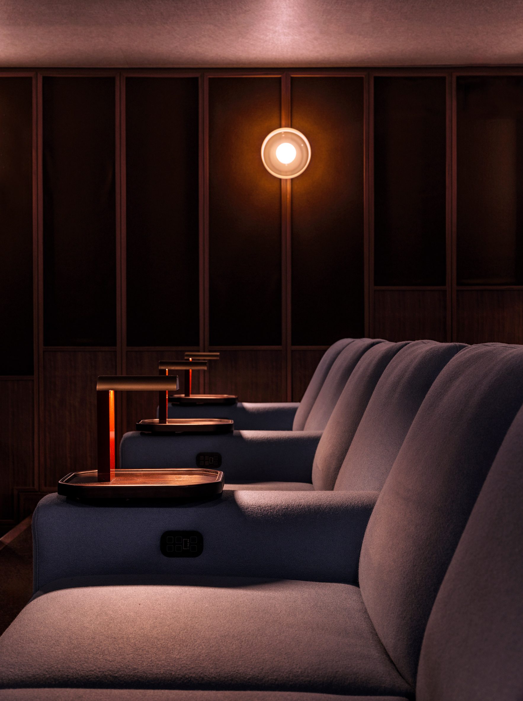 Screening room chairs with individual armrest tables