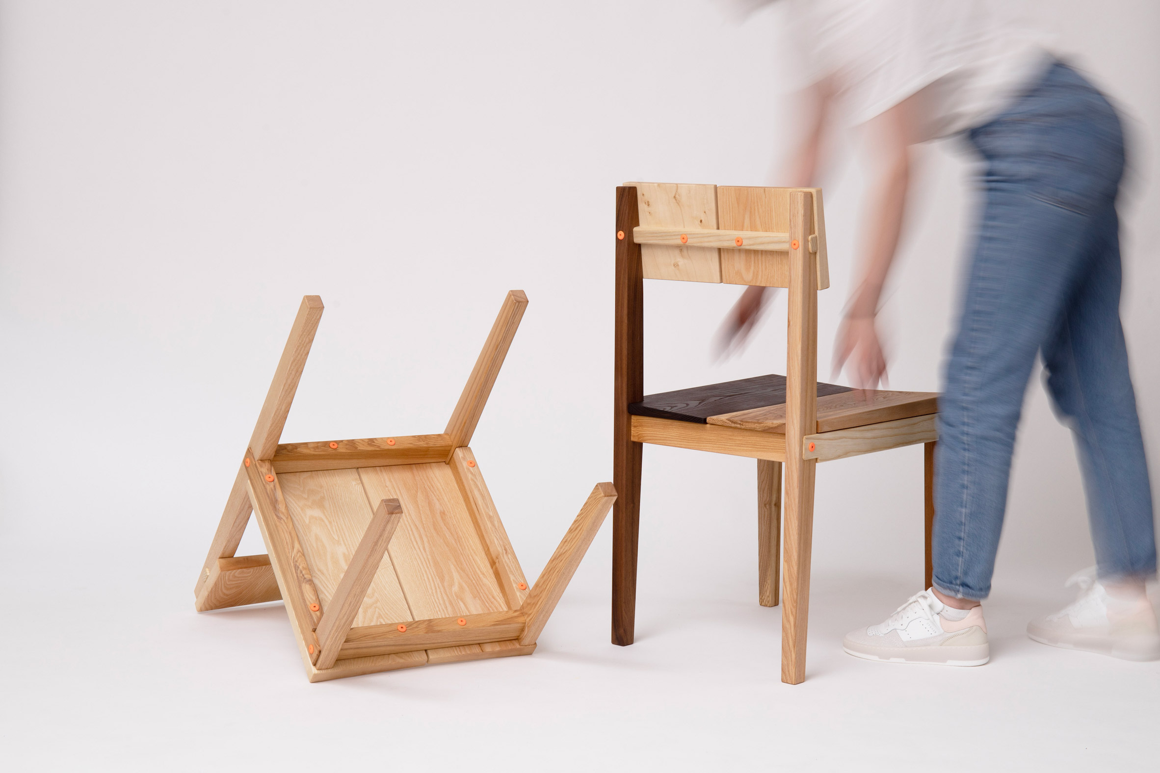 two chairs assembled with different woods