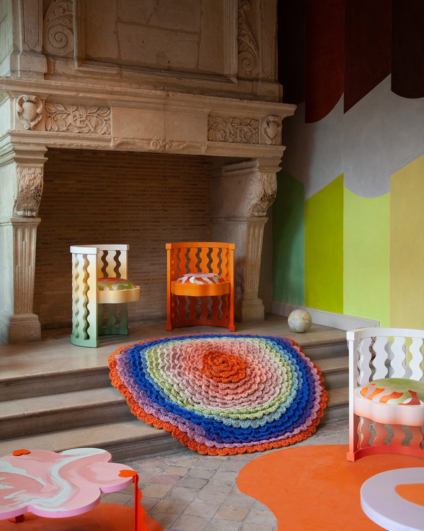 Brightly colored chairs and a CC-Tapis rug presented in the Think Pink installation from Uchronia