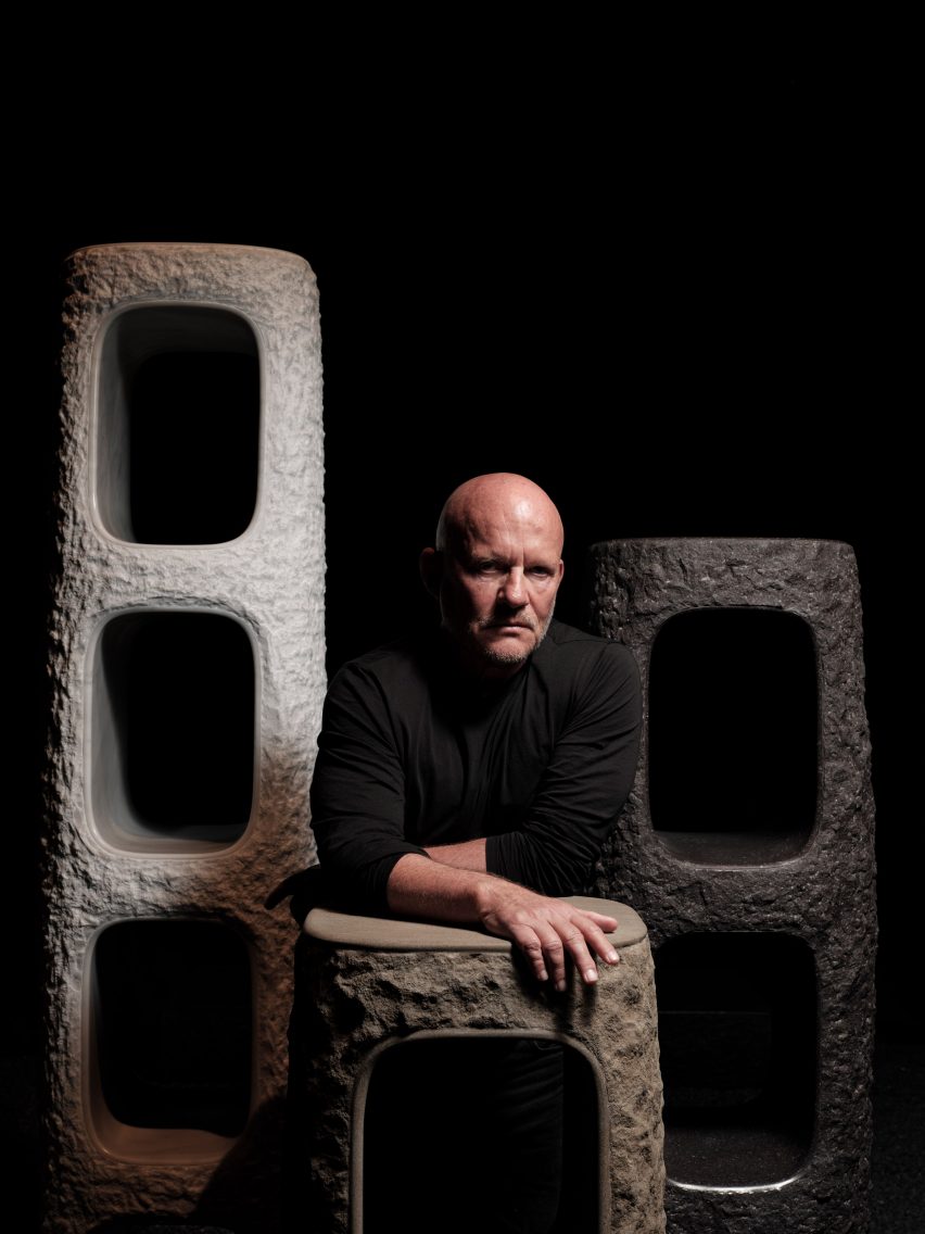 Vincent Van Duysen posing with stone shelves