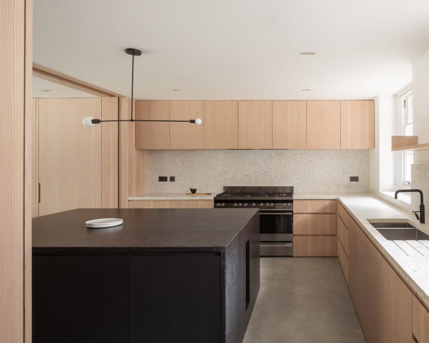 Kitchen with wooden units and a black island
