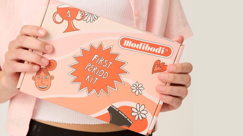 Model holding up Justyna Green's comic as part of Modibodi's First Period Kit, which depicts a teenage girl getting their first period