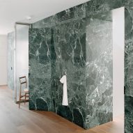 Monolithic green marble forms "majestic wall" in Milan apartment