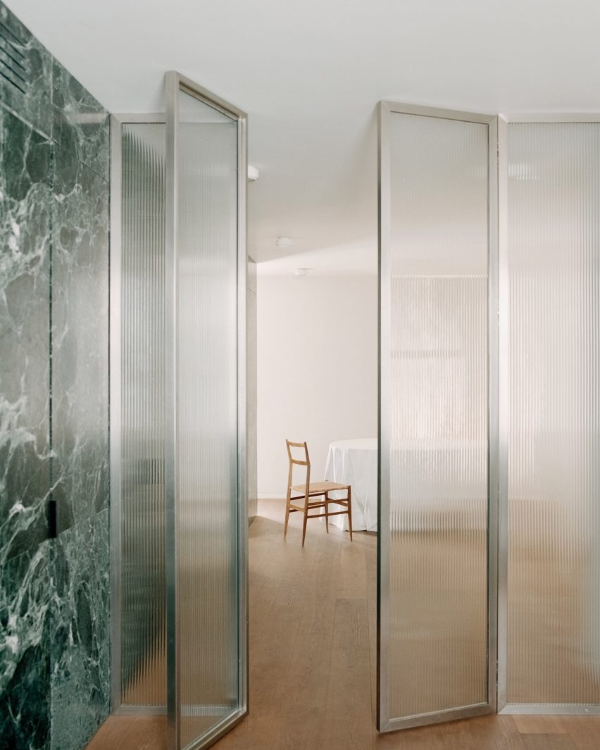 Full height glass divider in Green Nest Apartment by AIM Studio in Milan