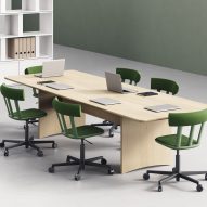 Green swivel chairs around table