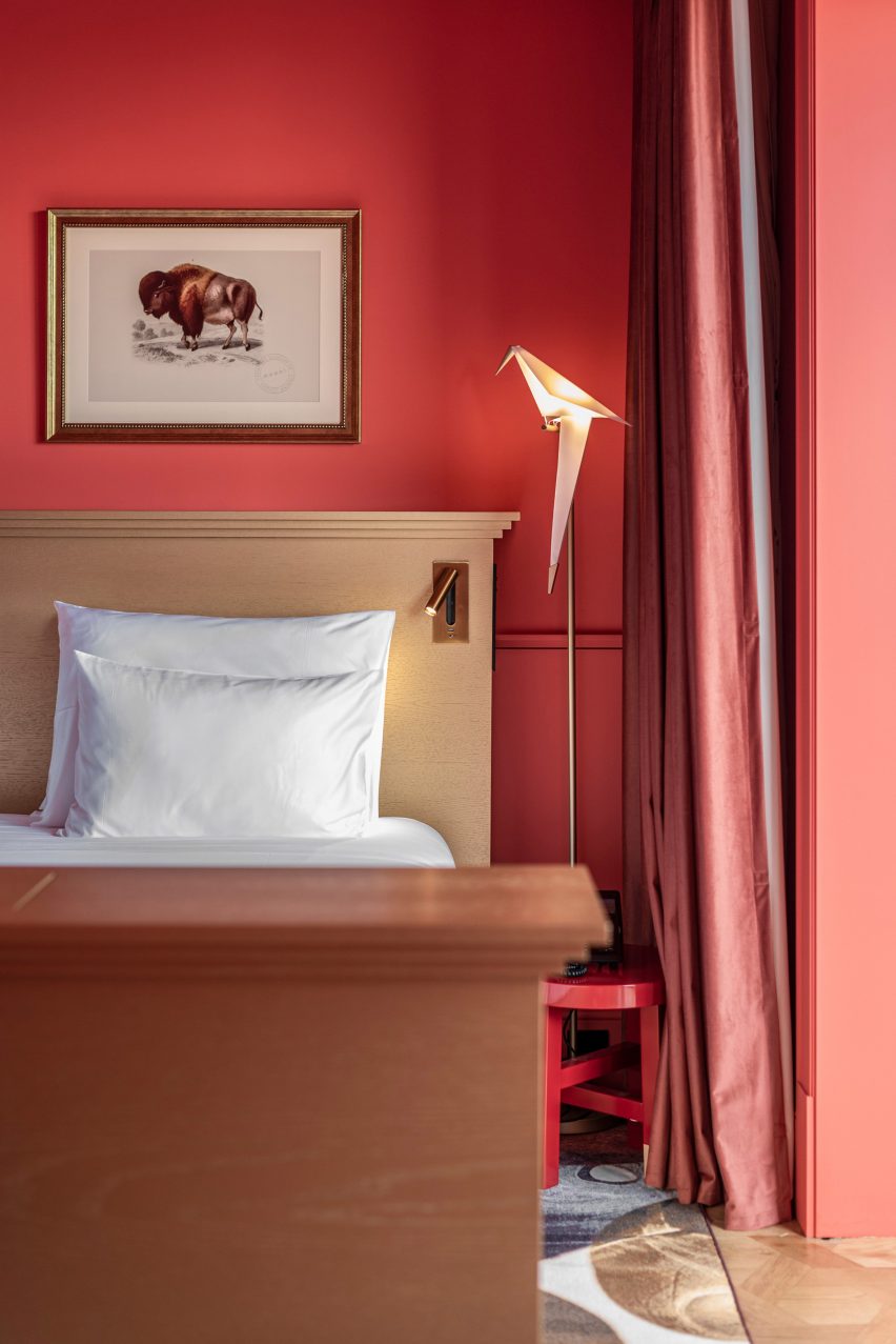 A room with a red colour scheme and Moooi lighting in the Art Legacy Hotel