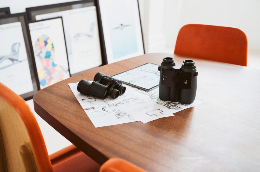 Photo of a sketching table with two pairs of AX Visio binoculars sitting on top of it