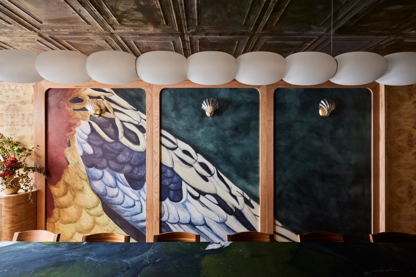 Trio of panels with hand-painted wallpaper displaying bird feathers