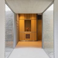 an entrance with wooden cabinetry at its end