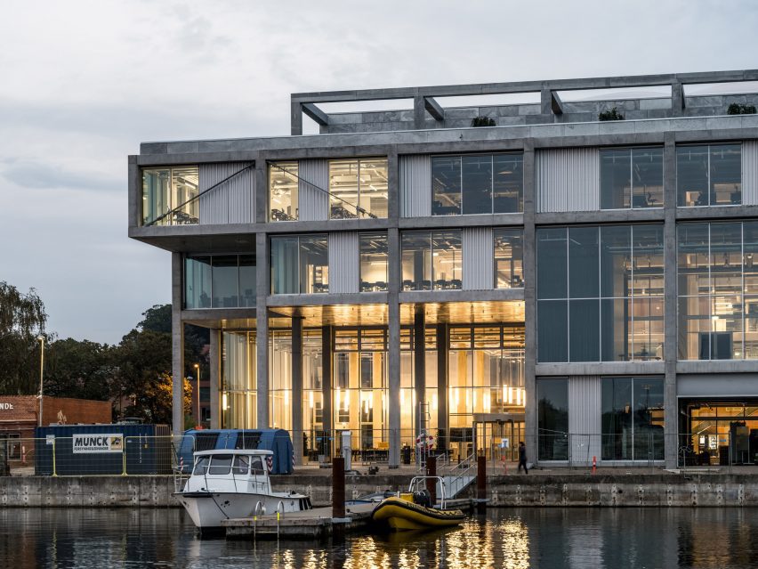 Facade dusk view of concrete maritime academy in Denmark by EFFEKT and CF Moller Architects