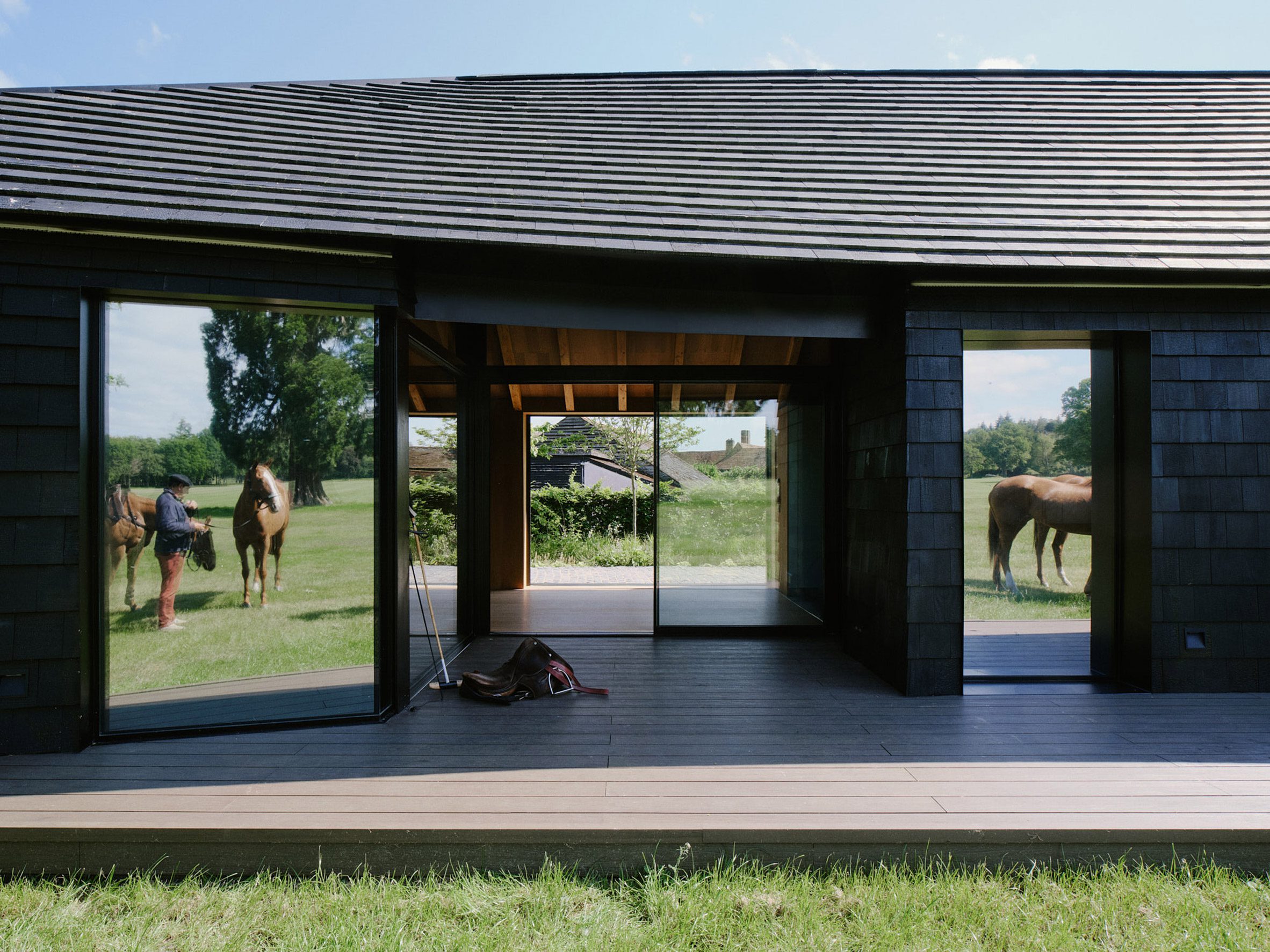 Timber-clad clubhouse at Arc Polo Farm by DROO