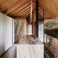 Barn-style kitchen interior with marble surfaces and island