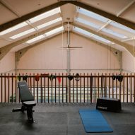 Barn-style interior with a mezzanine gym level